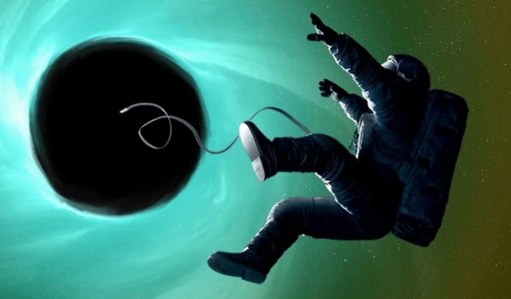 Изображение космонавта, затягиваемого в черную дыру
